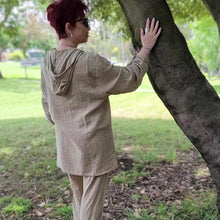 Load image into Gallery viewer, Ada-women&#39;s-muslin-hooded-button-front-shirt-in-latte-worn-with-women&#39;s-tie-waist-pants-latte-back-view
