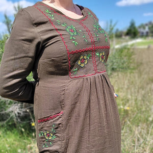 Honey-embroidered-maxi-dress-in-khaki-brown-featuring-embroidery-on-bust-and-front-pockets-close-up-view-of-embroidery-detail