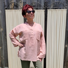 Load image into Gallery viewer, Ada-long-sleeve-Vneck-muslin-blouse-features-front-pockets-and-sleeve-tabs-in-peach-worn-with-khaki-muslin-pants-in-sunlight
