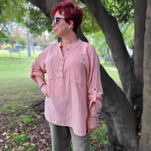 Load image into Gallery viewer, Ada-long-sleeve-Vneck-muslin-blouse-features-front-pockets-and-sleeve-tabs-in-peach-worn-with-khaki-muslin-pants
