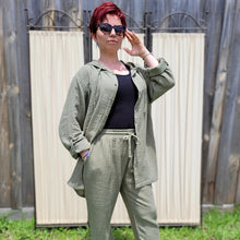 Load image into Gallery viewer, Ada-women&#39;s-muslin-hooded-button-front-shirt-in-khaki-worn-with-muslin-tie-waist-pants-khaki-layered-look-with-black-singlet
