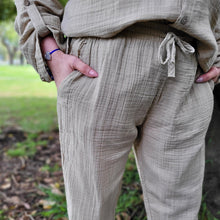 Load image into Gallery viewer, muslin-women&#39;s-tie-waist-pants-featuring-elasticated-string-tie-waist-and-side-pockets-in-latte-worn-with-Ada-muslin-hooded-shirt-in-latte-close-up-waist-detail
