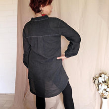 Load image into Gallery viewer, button-front-band-collar-tunic-shirt-with-button-tab-long-sleeves-mid-length-curved-hem-in-charcoal-worn-with-black-leggings-back-view
