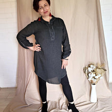 Load image into Gallery viewer, button-front-band-collar-tunic-shirt-with-button-tab-long-sleeves-mid-length-curved-hem-in-charcoal-worn-with-black-leggings-front-view
