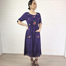 Load image into Gallery viewer, ashley-embroidered-midi-dress-with-embroidery-and-lace-detail-on-bodice-and-front-pockets-and-lace-on-hem-trim-in-purple-full-image
