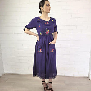 ashley-embroidered-midi-dress-with-embroidery-and-lace-detail-on-bodice-and-front-pockets-and-lace-on-hem-trim-in-purple-full-image