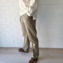 Load image into Gallery viewer, men&#39;s-cotton-chino-pants-with-elasticated-waist-at-back-side-pockets-and-buttoned-back-pockets-in-khaki-side-view
