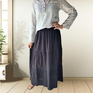 dahlia-tiered-maxi-skirt-with-lace-trim-in-black-worn-with-V-neck-blouse-in-stone-and-brown-leather-sandals-front-view