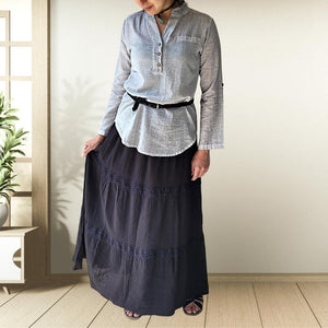 dahlia-tiered-maxi-skirt-with-lace-trim-in-black-worn-with-V-neck-blouse-in-stone-and-black-thin-belt-and-leather-sandals-front-view