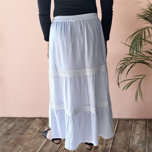 dahlia-tiered-maxi-skirt-with-lace-trim-in-white-worn-with-black-top-and-sandals-back-view