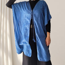 Load image into Gallery viewer, cotton-kimono-tunic-with-V-neckline-short-batwing-sleeves-and-straight-hemline-with-lace-edging-and-front-string-tie-with-tassel-trim-in-indigo-worn-with-black-wide-leg-pants-and-top-front-view
