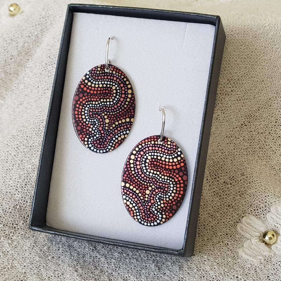 handmade-flat-oval-earrings-featuring-essence-at-dusk-indigenous-artwork-imprinted-on-aluminium-sheeting-with-sterling-silver-hooks-in-gift-box