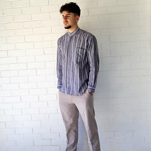 long-sleeve-shirt-with-band-collar-button-up-front-and-single-chest-pocket-in-striped-grey-worn-with-chino-pants-in-light-grey-front-view