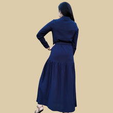 Load image into Gallery viewer, long-sleeve-button-through-cotton-maxi-dress-in-navy-with-fabric-belt-shirt-collar-buttoned-cuffs-and-gathered-tier-in-skirt-from-the-hips-back-view
