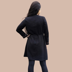 long-sleeve-brushed-cotton-tunic-dress-in-black-with-embroidery-detail-on-sleeve-cuffs-showing-string-tie-waist-back