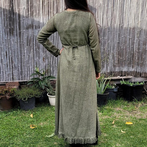 long-sleeve-cotton-maxi-dress-in-khaki-with-eyelet-embroidery-on-front-sides-pintuck-detail-on-chest-lace-frill-at-skirt-hem-showing-string-tie-at-waist-back