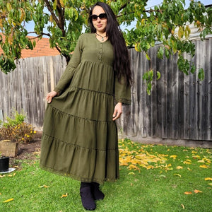 brushed-cotton-flannel-tiered-maxi-dress-in-khaki-with-V-neck-buttoned-chest-bell-sleeves-with-tassel-ties-lace-trim-on-sleeves-and-skirt-hem-and-string-tie-waist