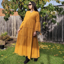 Load image into Gallery viewer, brushed-cotton-flannel-tiered-maxi-dress-in-mustard-with-V-neck-buttoned-chest-bell-sleeves-with-tassel-ties-lace-trim-on-sleeves-and-skirt-hem-and-string-tie-waist
