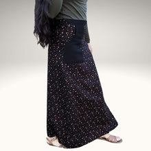 Load image into Gallery viewer, high-waisted-brushed-cotton-flannel-maxi-skirt-in-black-with-ditsy-floral-print-accent-pocket-on-front-right-in-solid-black-and-button-through-off-centre-front-slit-side-view
