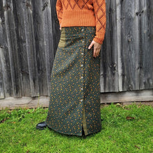 Load image into Gallery viewer, high-waisted-brushed-cotton-flannel-maxi-skirt-in-khaki-with-ditsy-floral-print-accent-pocket-on-front-right-in-solid-khaki-and-button-through-off-centre-front-slit-side-view
